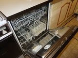 a dishwasher that is open in a kitchen