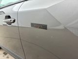 a silver car with a sticker on the side of it