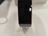 a smart watch sitting on a table next to a cell phone