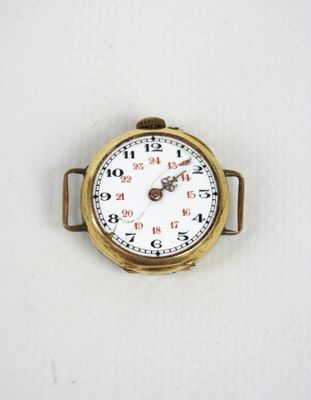 a close up of a pocket watch on a white surface