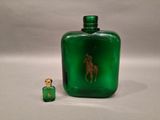a green glass bottle with a gold horse on it