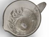 a glass cup with a flower inside of it