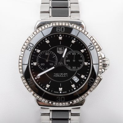 a close up of a watch on a white surface