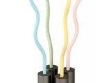 a glass table with three different colored sticks on it