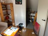a living room with a couch, table, and bookshelf in it