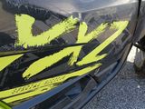 a close up of a vehicle with a yellow sticker on it ' s side