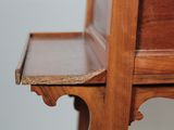 a close up of a wooden table with a drawer on it