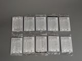 six packs of electronic batteries in plastic bags on a table