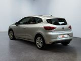 the rear end of a silver car in a white room
