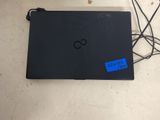 an open laptop computer sitting on top of a table next to some wires