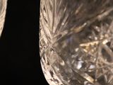 two empty wine glasses sitting on top of each other on a table
