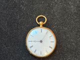 an image of a gold pocket watch with roman numerals and roman numerals on the face