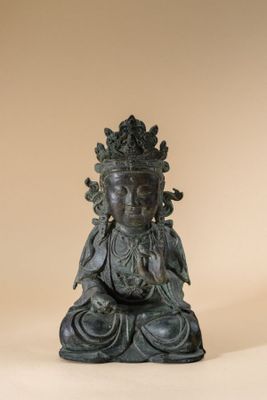 an image of a statue of a buddha sitting on a white surface