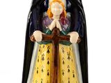 figurine représentant une femme avec un enfant sur un cheval à bascule