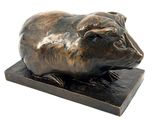 bronze sculpture of a pig on a wooden base on a white background