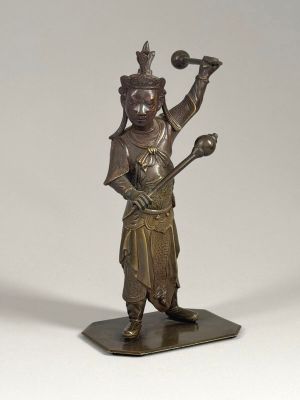 bronze statue of a man holding a baseball bat and a ball