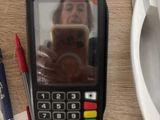 a woman taking a picture of her selfie in the mirror of a pos machine