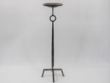 a black iron candle stand with a circular ring on top