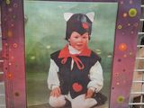 a picture of a picture of a child in a costume