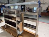 a large metal shelf with several shelves on it in a warehouse