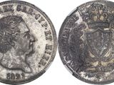 a close up of a coin with a crown on it