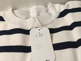 the sweater has a tag on the front of it that says it is made of wool