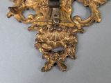 an antique brass candle holder with a candle on top of it