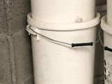 three buckets stacked on top of each other in a room