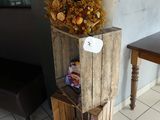 une caisse en bois sur laquelle est posé un bouquet de fleurs