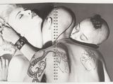 black and white photograph of a man and a woman with tattoos on their backs