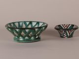 two green and white bowls sitting next to each other on a table