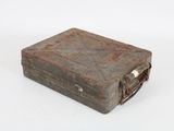 an old metal box that is sitting on a white surface