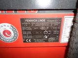a close up of a red machine with a black label on it