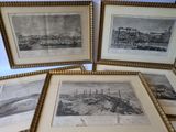 four framed pictures of ships in a row on a table