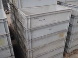 many crates stacked on top of each other in a warehouse