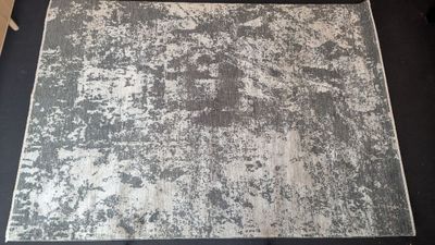 a black and white rug on a black table