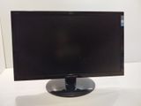 a computer monitor sitting on top of a white table