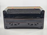 a black and gold keyboard sitting on top of a black box