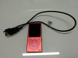 a red mp3 player with a cable attached to it