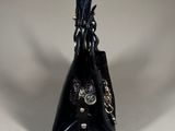 an image of a black purse on a white surface