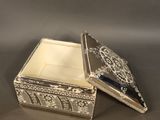 a small silver box with a lid on a table