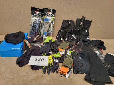 several pairs of gloves, gloves, gloves, gloves, and other items are on the floor