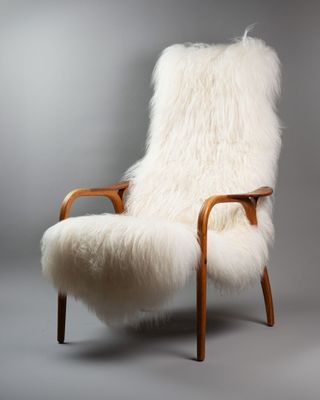 an image of a white sheepskin chair with a wooden frame