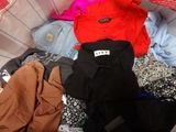 a basket full of clothes that is sitting on the floor