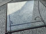 a glass table with a metal frame and a glass top