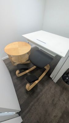 un bureau avec une chaise et une table dans un coin de la pièce