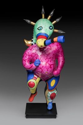a statue of a colorful bird with spikes on its head
