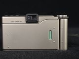 a silver camera that is sitting on a black surface