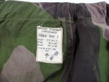 a close up of a camouflage jacket with a tag on it