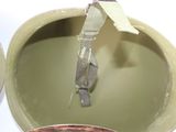 a close up view of a military helmet with a metal buckle